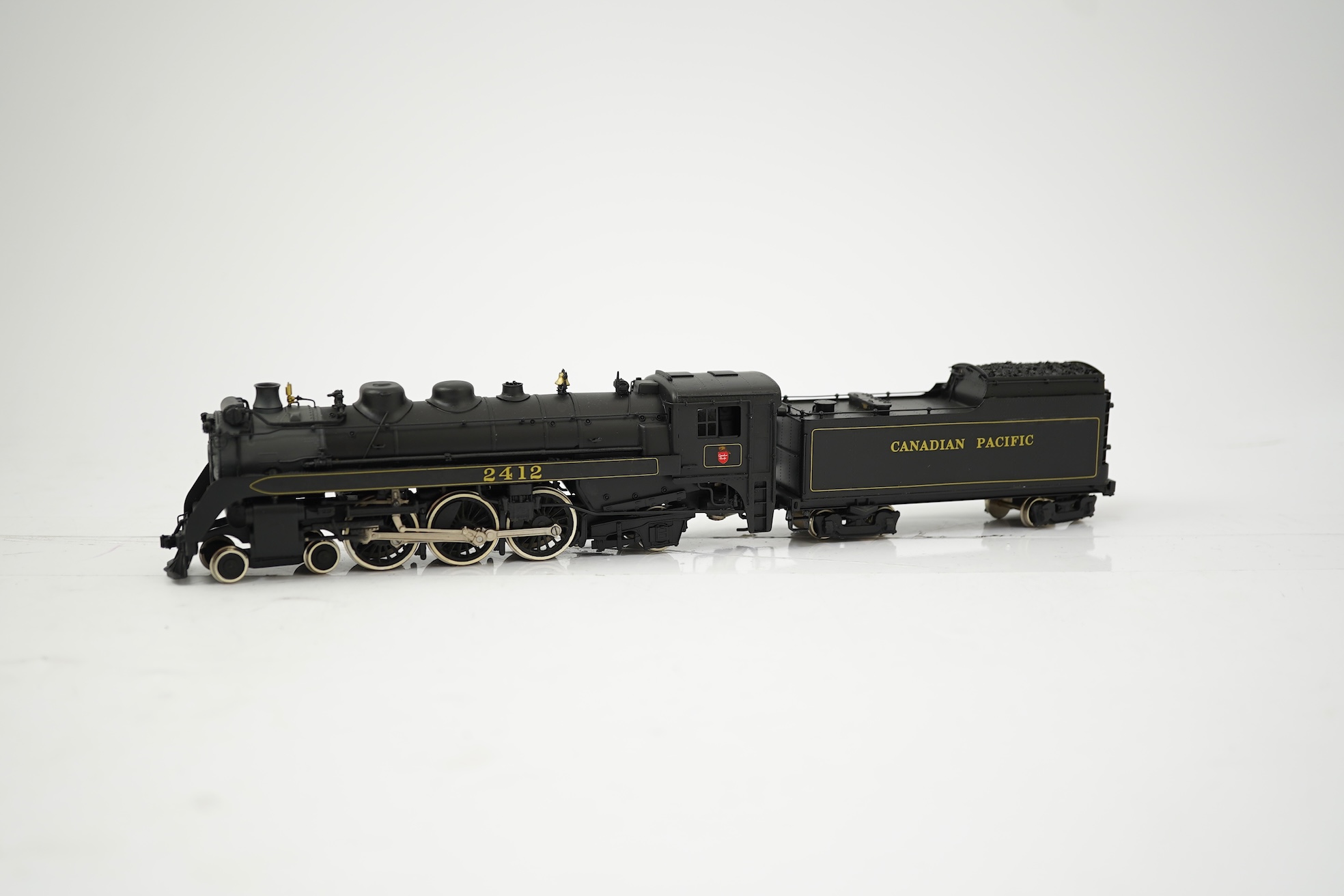 Two boxed HO gauge Canadian Pacific locomotives; a Toby of Japan model of 2412, 4-6-2 locomotive with bogie tender, together with a United Scale Models 3710, 2-8-0 locomotive with bogie tender, both powered for two rail